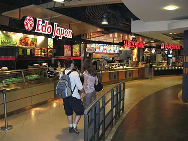 A vibrant view of the food court in Migsun Rohini Central, featuring various dining outlets and customers enjoying meals in a spacious, modern setting.