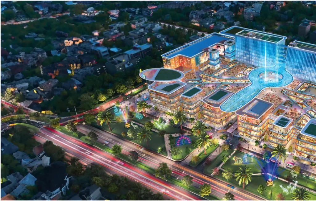 A colorful night view of Migsun Rohini Central, featuring well-lit palm trees, outdoor spaces, and a sprawling commercial complex with futuristic design in Sector 22, Rohini, Delhi.