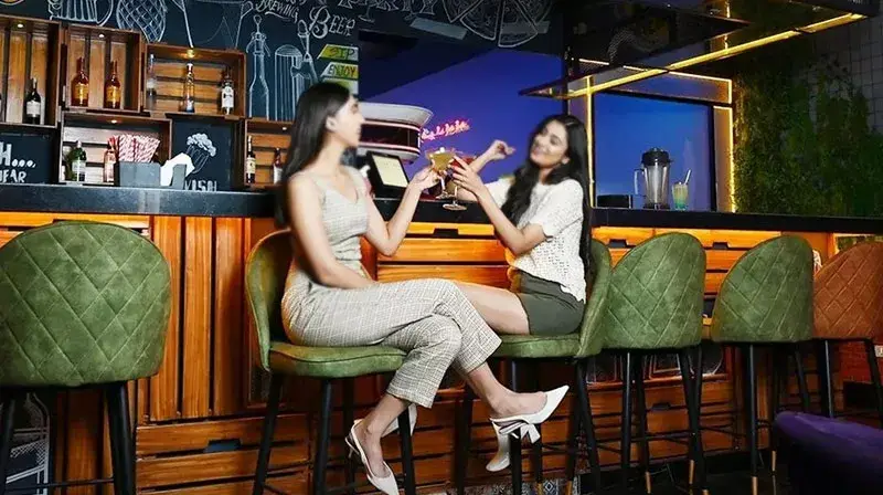 two women sitting at a bar